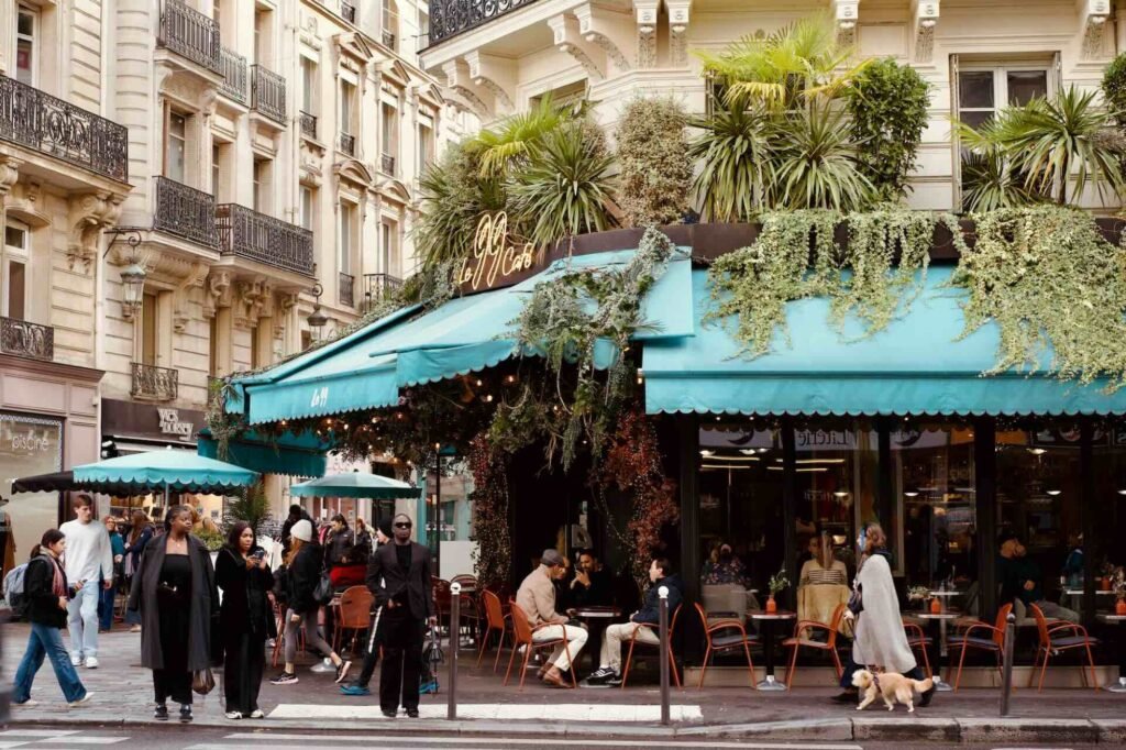 A Paris café terrace under green awnings