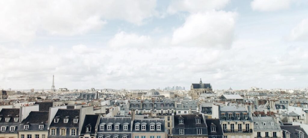 Paris rooftops under a cloudy sky
