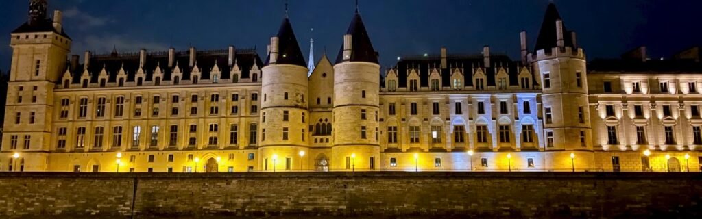 The Conciergerie lit up at night